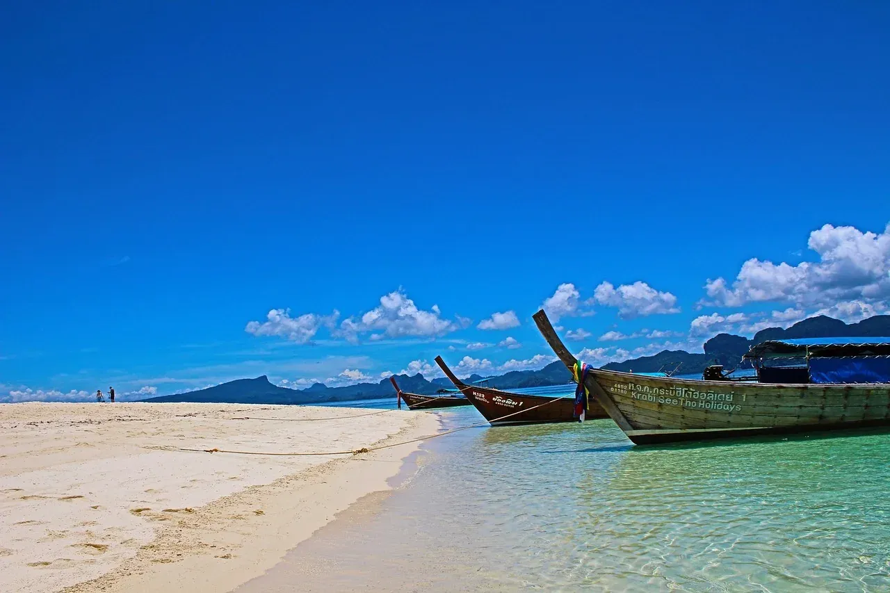 A beach backed by limestone headlands in Krabi province
