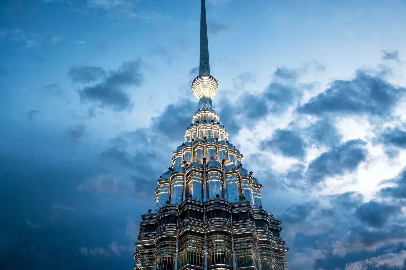 Top of the Petronas Towers against an evening sky in Kuala Lumpur