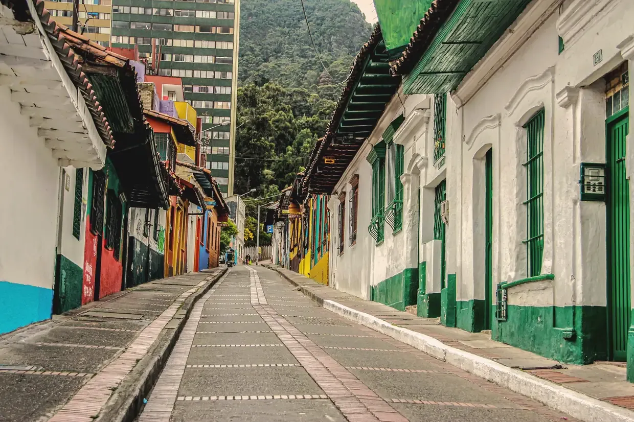 Colourful colonial houses lining a cobbled street in the La Candelaria district of Bogota, Colombia