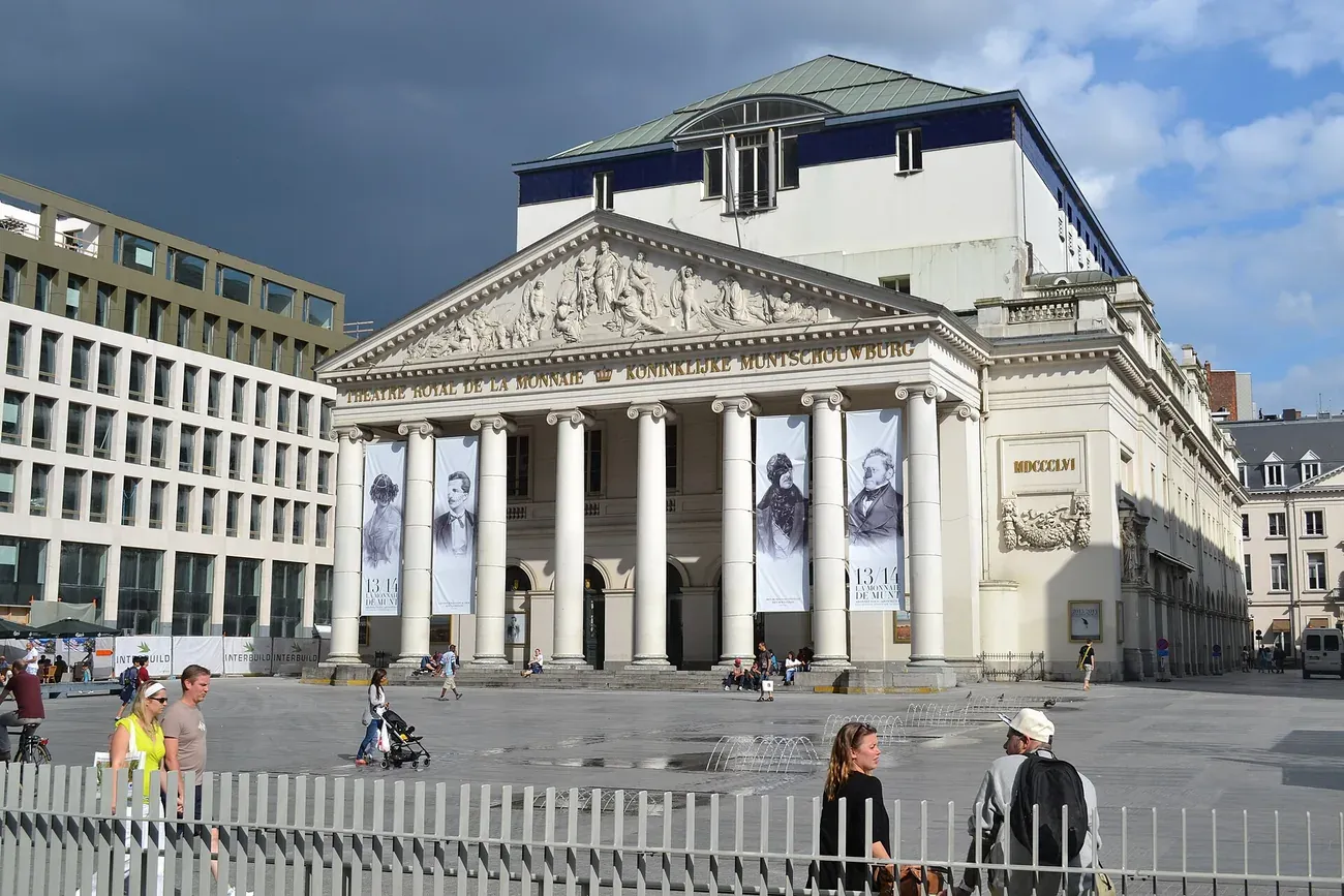The neoclassical facade of La Monnaie opera house on the Place de la Monnaie in Brussels