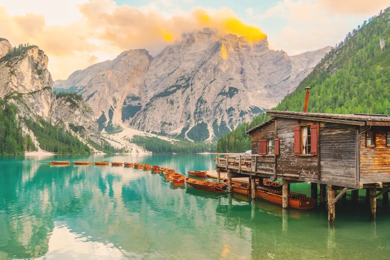 The wooden boathouse and rowboats on Lago di Braies in the Dolomites, Italy