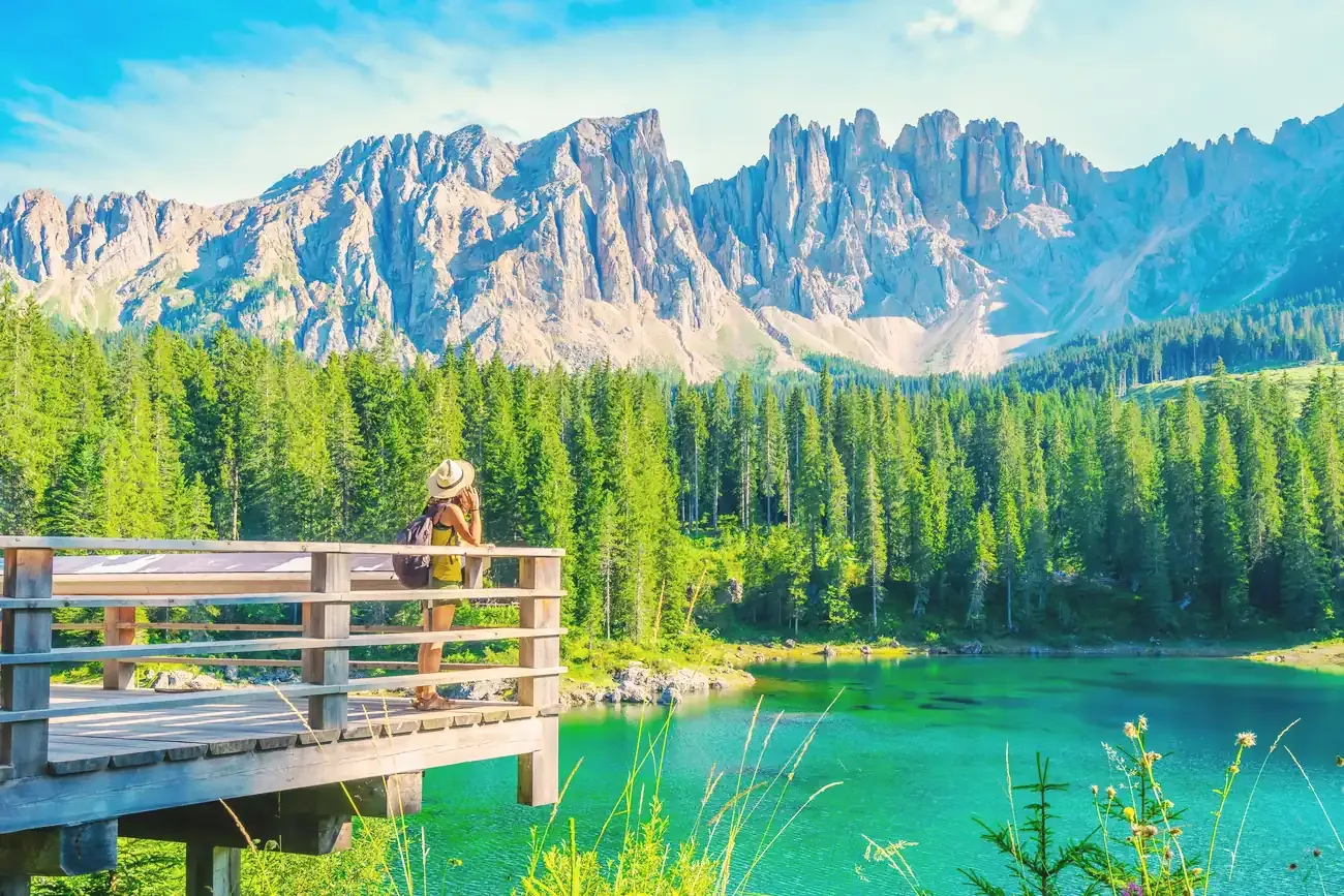 Emerald water of Lake Carezza below the Latemar massif in the Dolomites, Italy