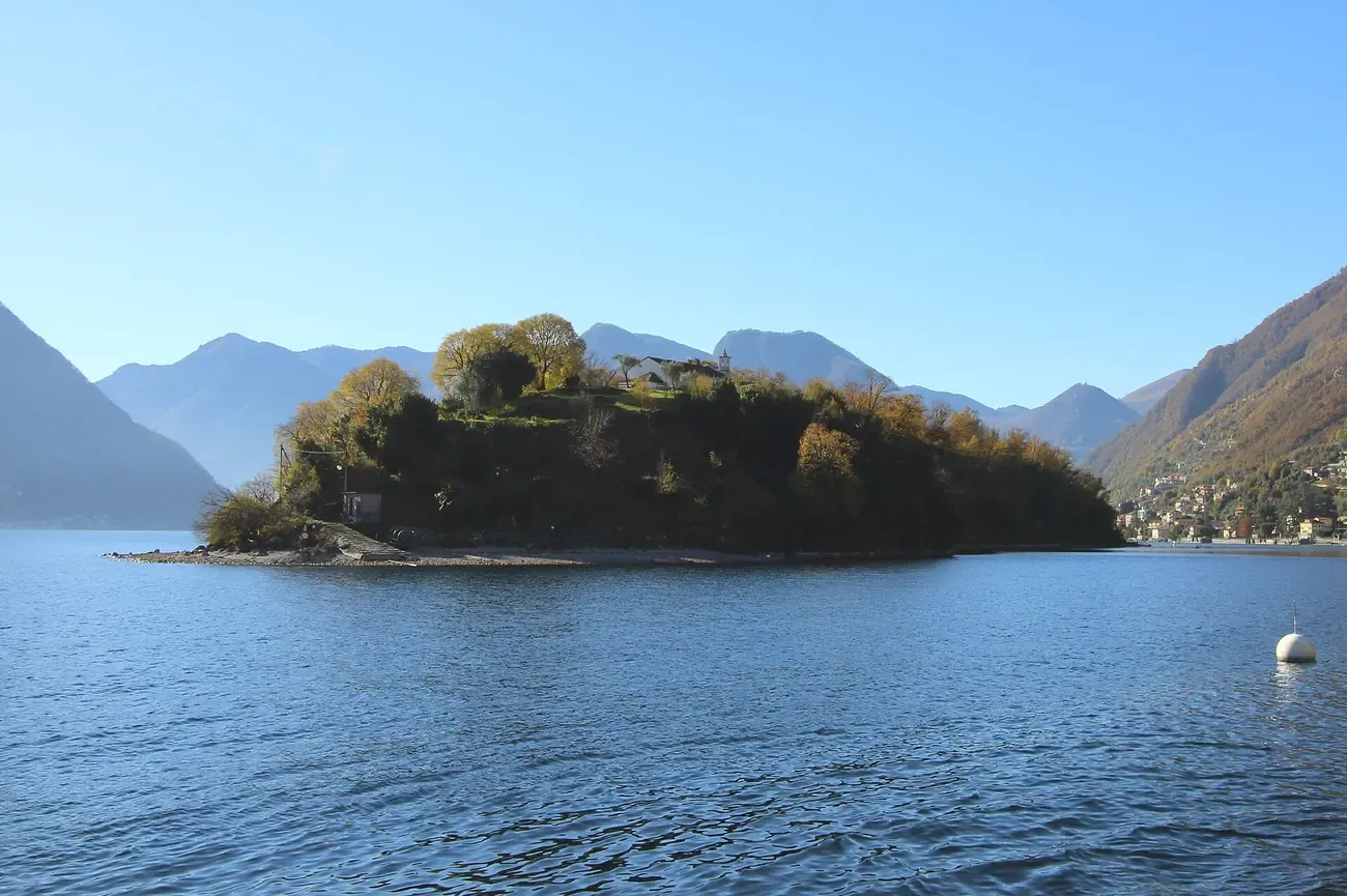 The wooded Isola Comacina, the only island in Lake Como, seen from the water