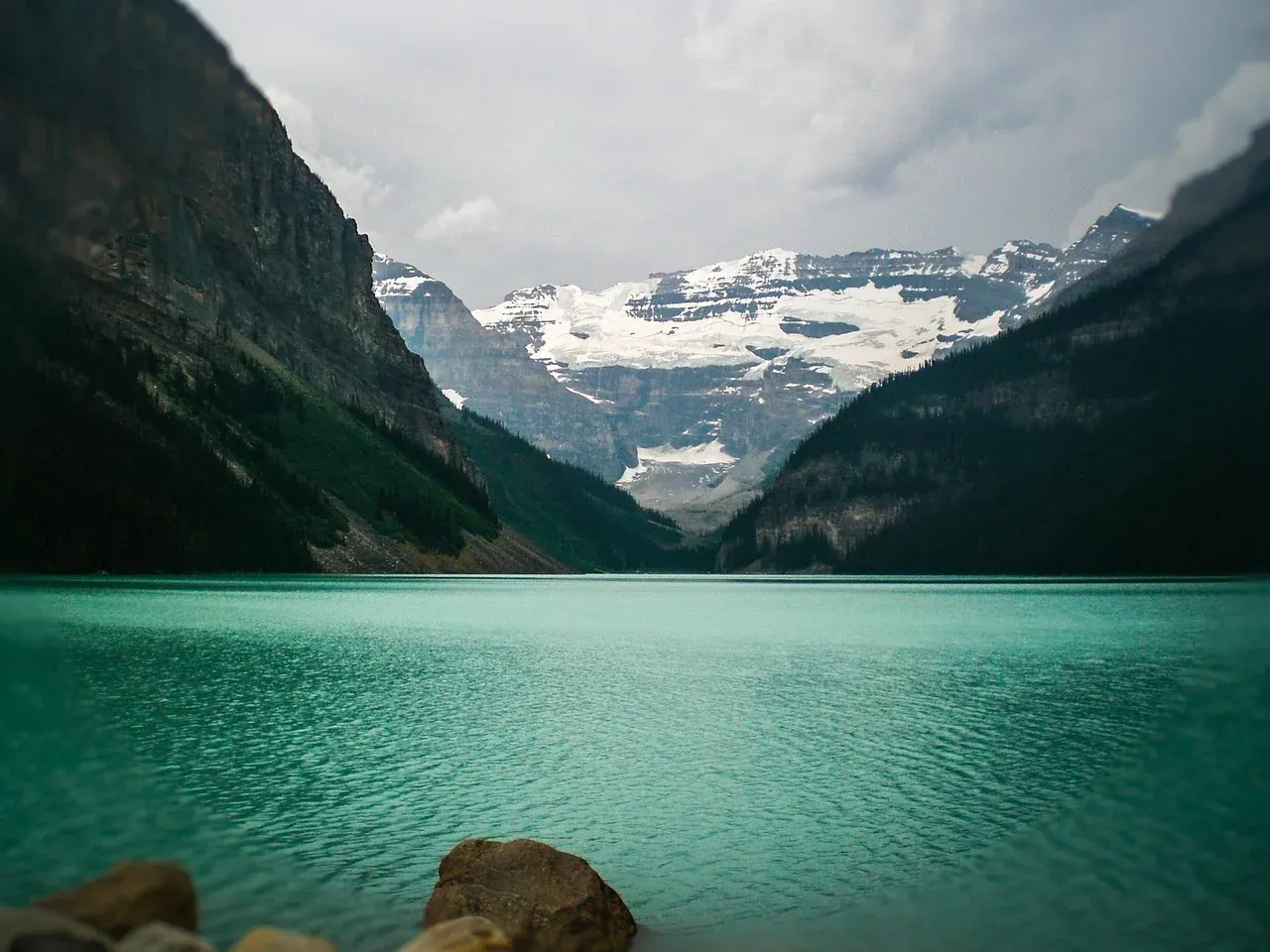 Still water at Lake Louise with the glacier at the head of the valley