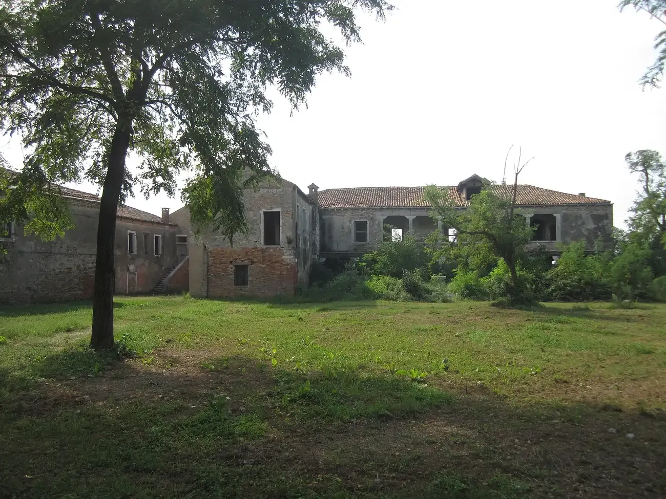 The abandoned brick buildings of the Lazzaretto Vecchio plague quarantine island in the Venetian lagoon
