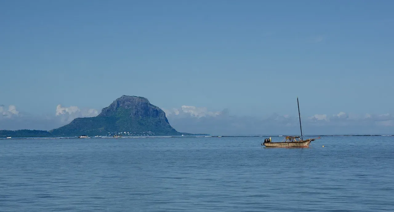 Le Morne Brabant mountain and a fishing boat off the coast of Mauritius