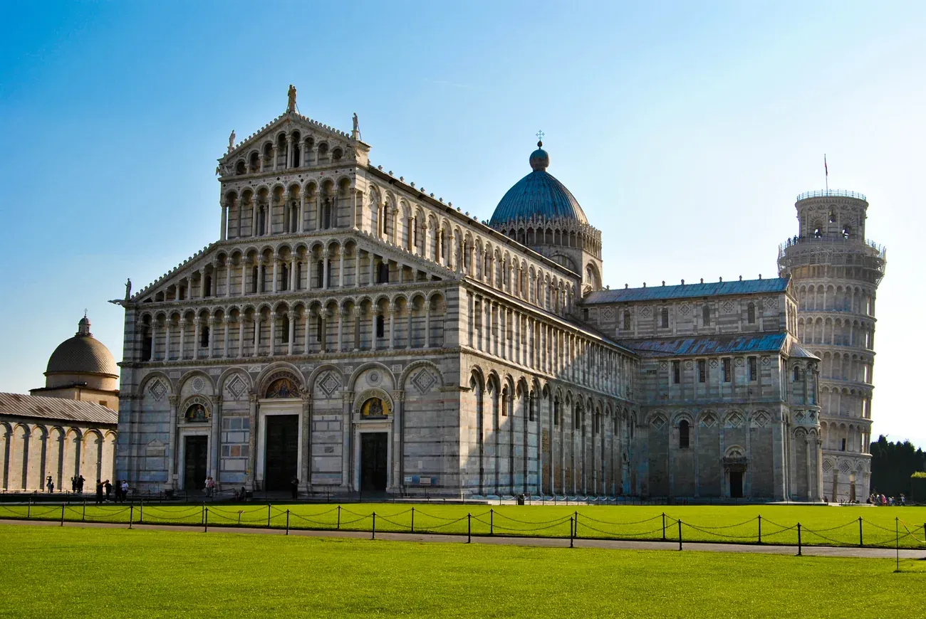 The Leaning Tower of Pisa beside the Cathedral's facade in the Piazza dei Miracoli