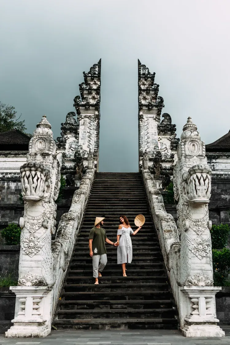 A couple on the stairway of the Lempuyang Temple 'Gates of Heaven' split gate in Bali