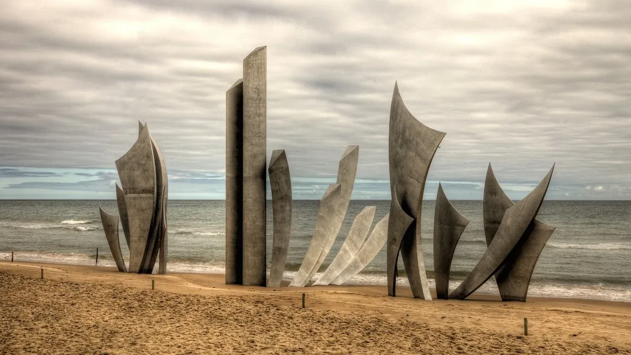 The Les Braves memorial standing on the sand of Omaha Beach, Normandy