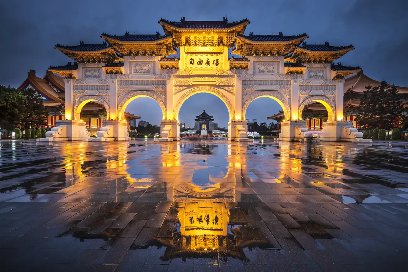 The Liberty Square gate reflected on wet ground at dusk, Taipei