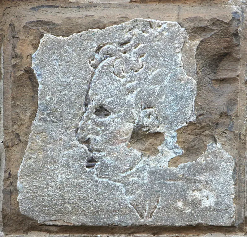 The small carved profile known as L'importuno cut into a stone block at the corner of Palazzo Vecchio in Florence