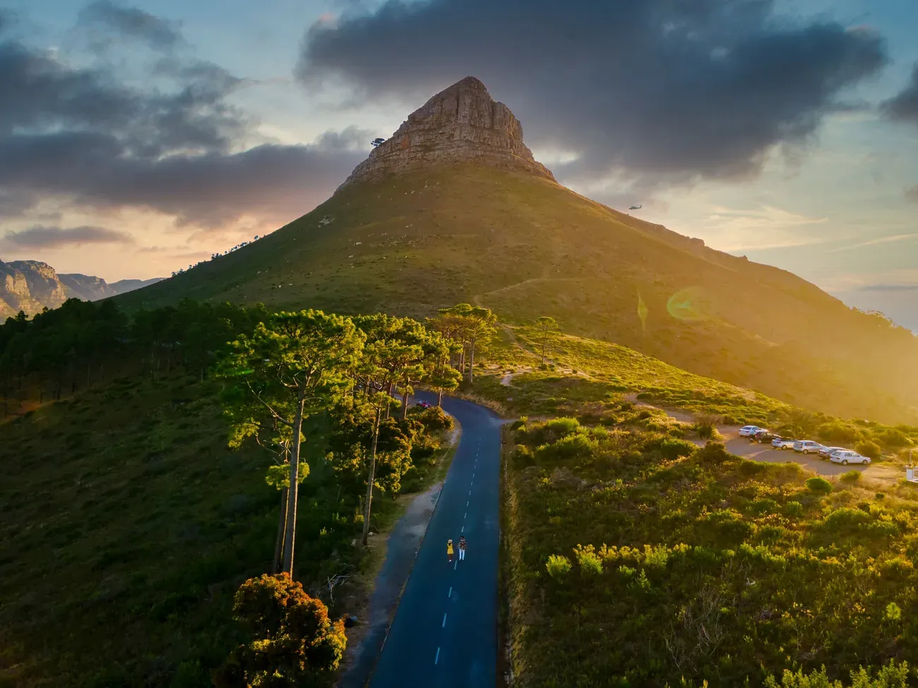 Lion's Head mountain above a winding coastal road, Cape Town