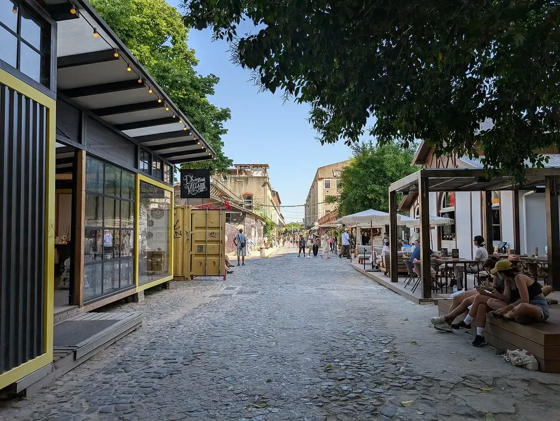 The cobblestone street lined with shops and cafes inside the LX Factory creative complex in Lisbon