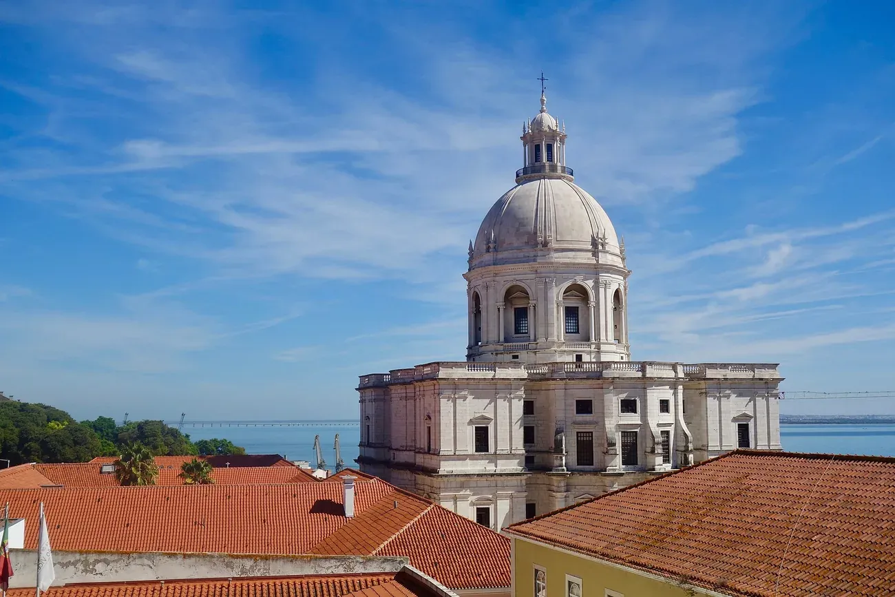 The white baroque dome of the Church of Santa Engracia, Lisbon's National Pantheon, seen above the rooftops of Alfama