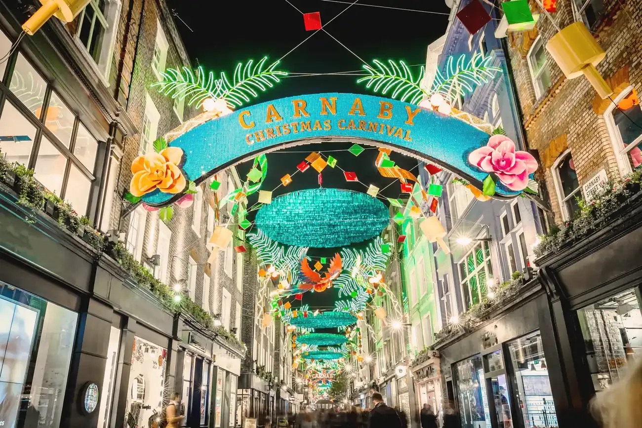 Colourful Christmas installation hanging over Carnaby Street in London at night
