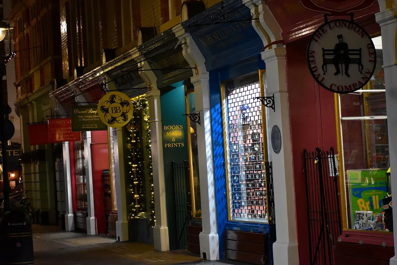 Colourful antiquarian bookshop and print dealer shopfronts along Cecil Court in London