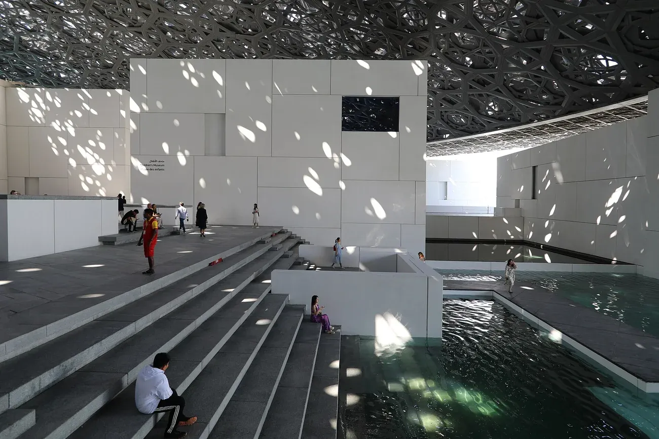 Dappled light falling on the covered courtyard of Louvre Abu Dhabi