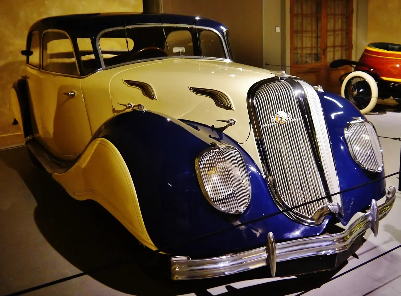 A streamlined art deco car on display at the Louwman Museum in The Hague