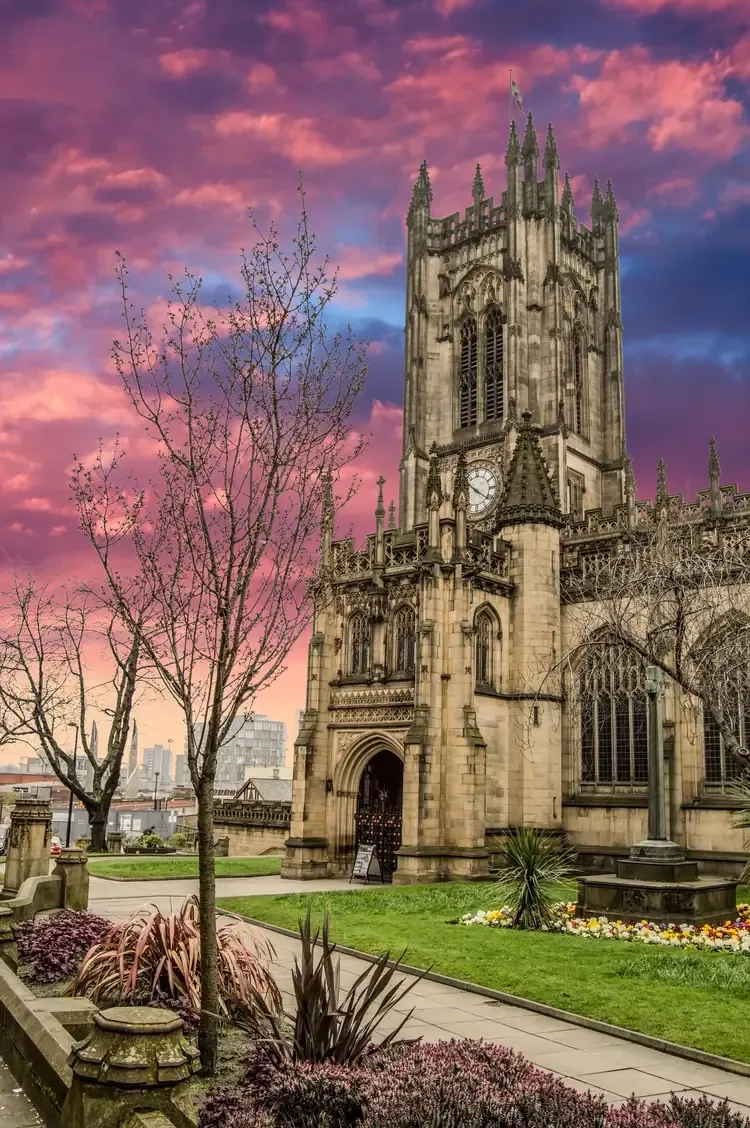 Manchester Cathedral under a pink sunset sky