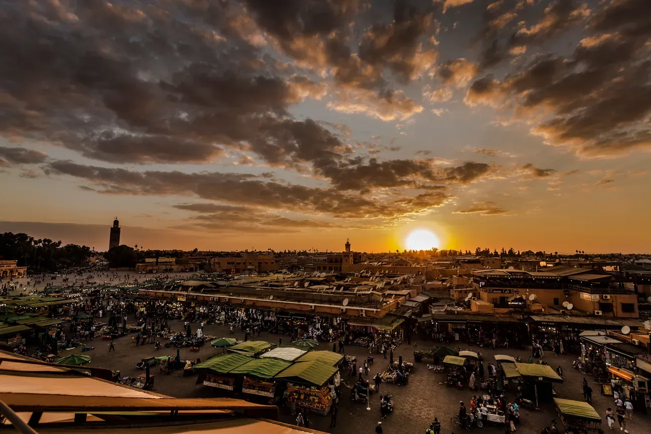 Sun setting over the rooftops and market stalls of Jemaa el-Fnaa in Marrakech