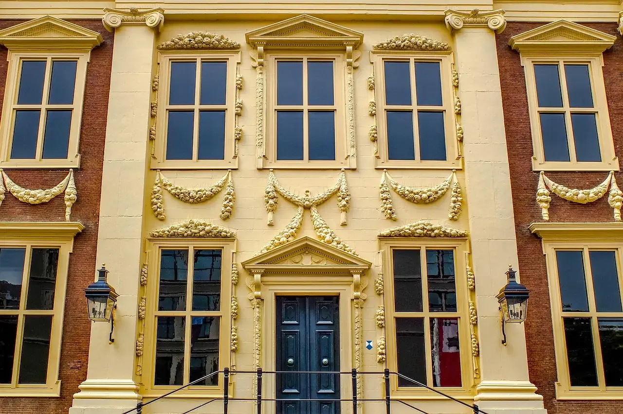 Detail of the ochre sandstone front and festoons of the Mauritshuis in The Hague