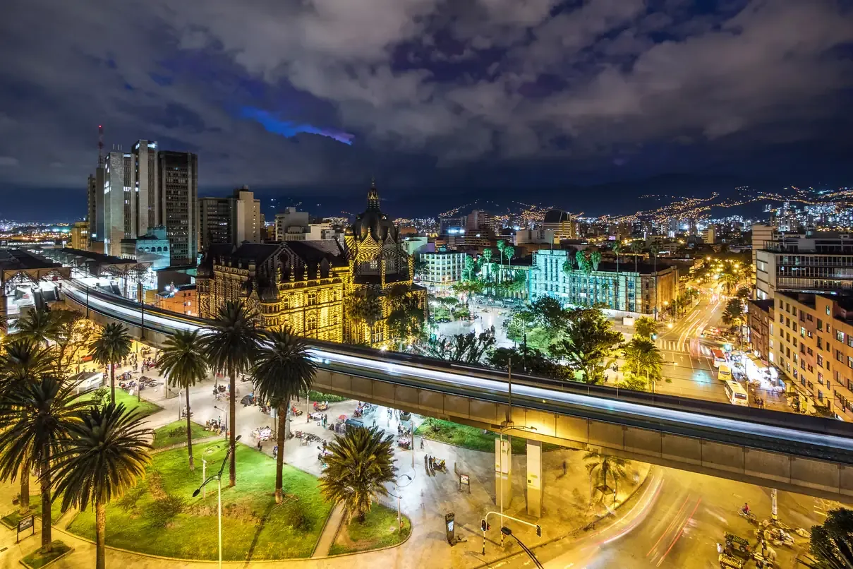 The Medellin cityscape and plaza illuminated at night