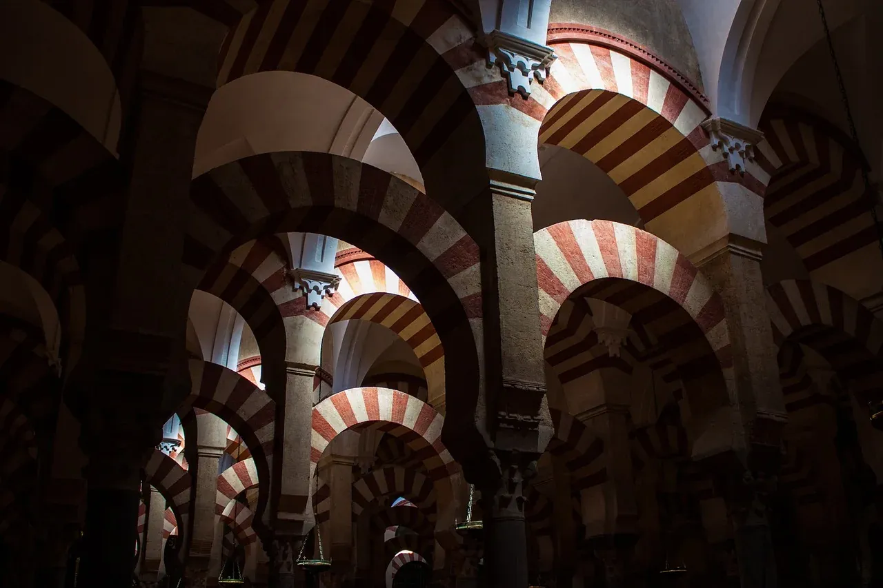 The red and white double arches of the prayer hall in the Mosque-Cathedral of Cordoba
