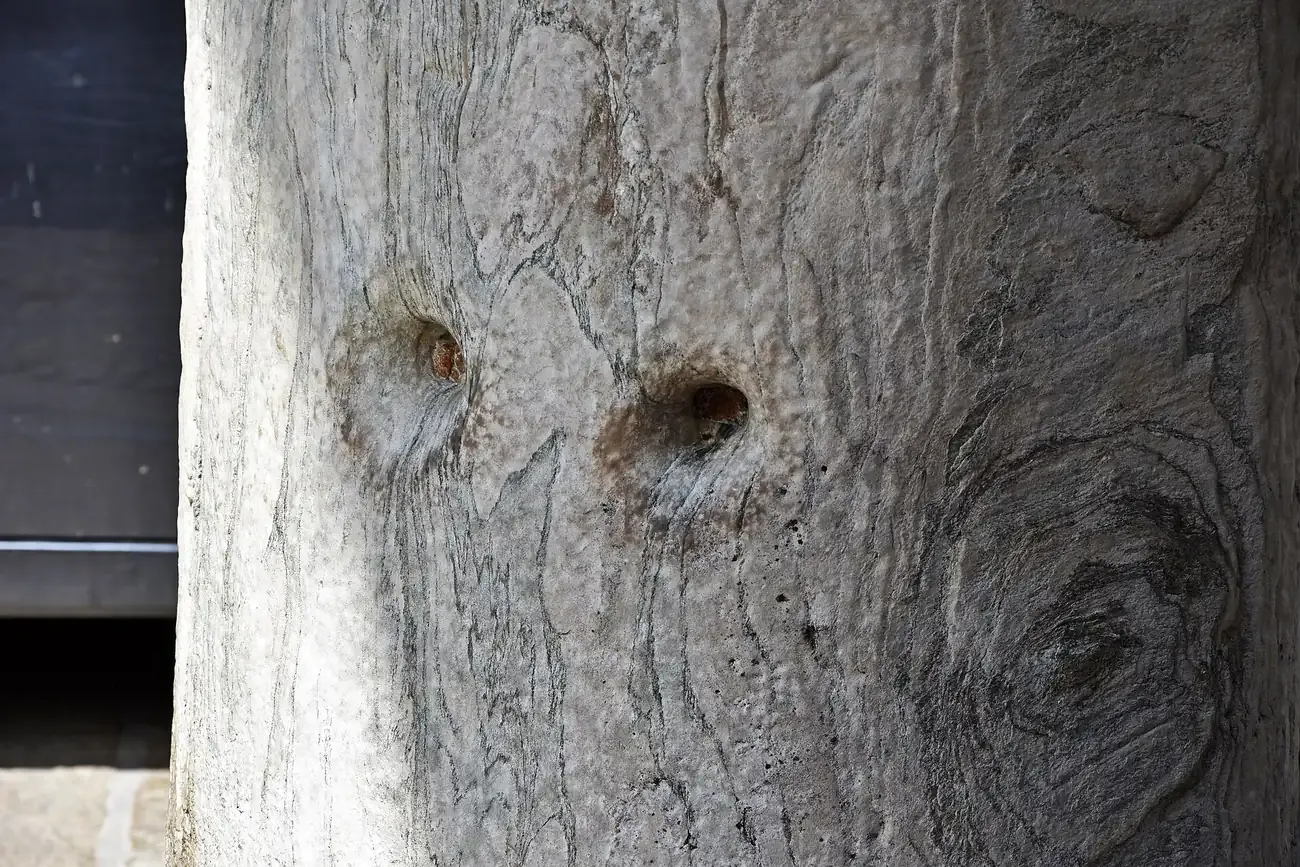 Close-up of the Roman marble Devil's Column outside Sant'Ambrogio in Milan with its two legendary holes