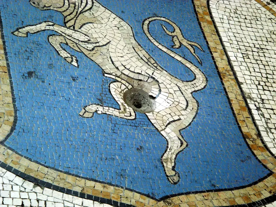 The Turin bull mosaic on the floor of the Galleria Vittorio Emanuele II in Milan, with the worn hole where visitors spin their heel for luck