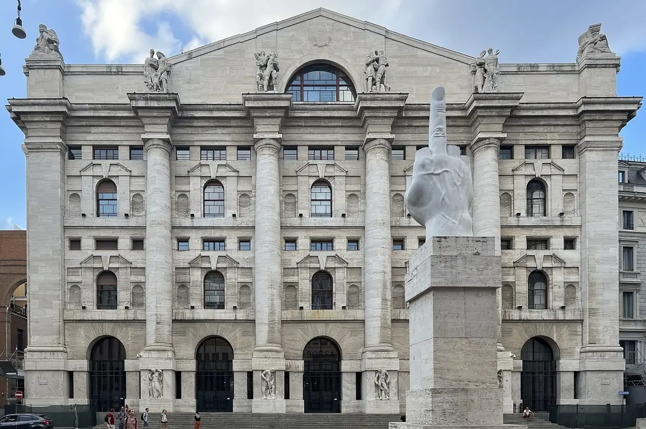 Maurizio Cattelan's marble hand sculpture L.O.V.E. on its plinth in front of the Palazzo Mezzanotte stock exchange in Piazza degli Affari, Milan