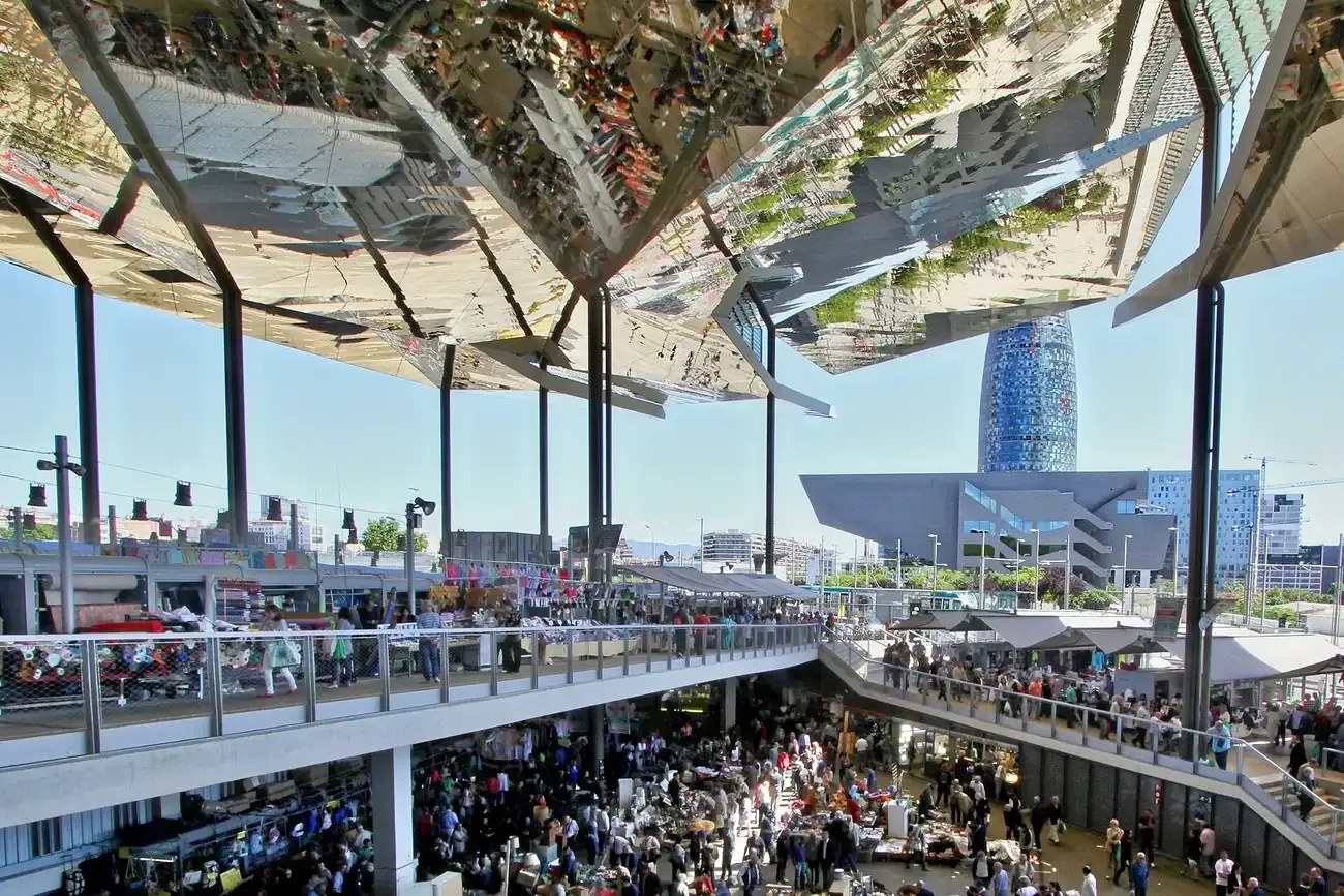 Mirror roof of Els Encants flea market with Torre Glories in Barcelona
