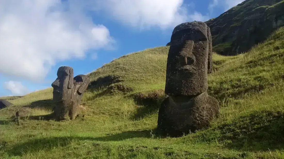 Moai standing on the grassy slopes of the Rano Raraku quarry, Easter Island