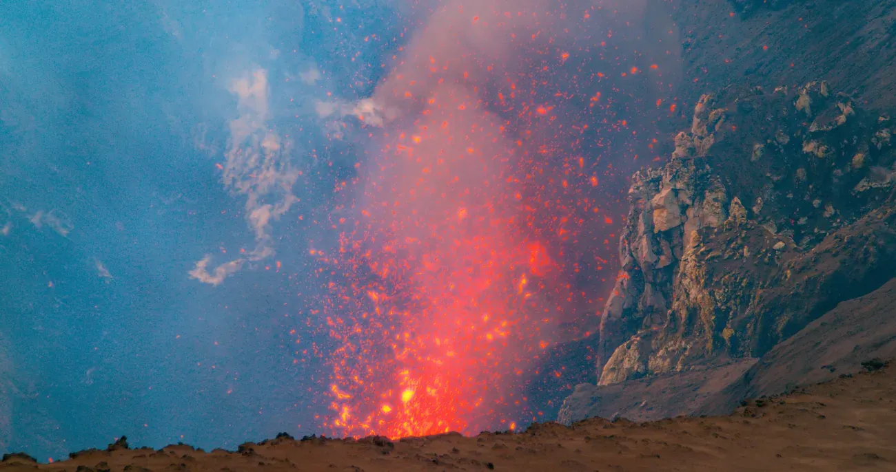 Bursts of molten lava thrown up from the crater of Mount Yasur at night, Tanna, Vanuatu
