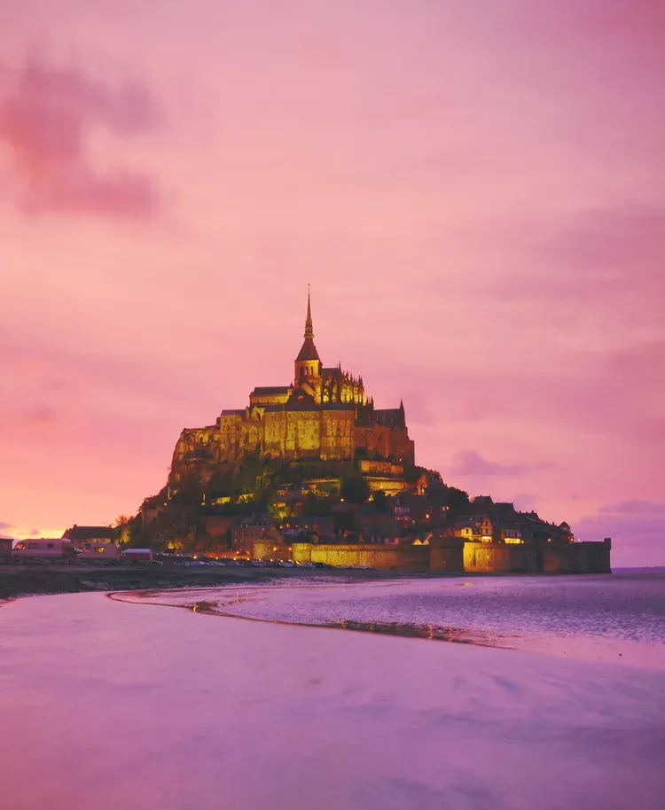 Mont Saint-Michel abbey silhouetted at sunset, Normandy, France