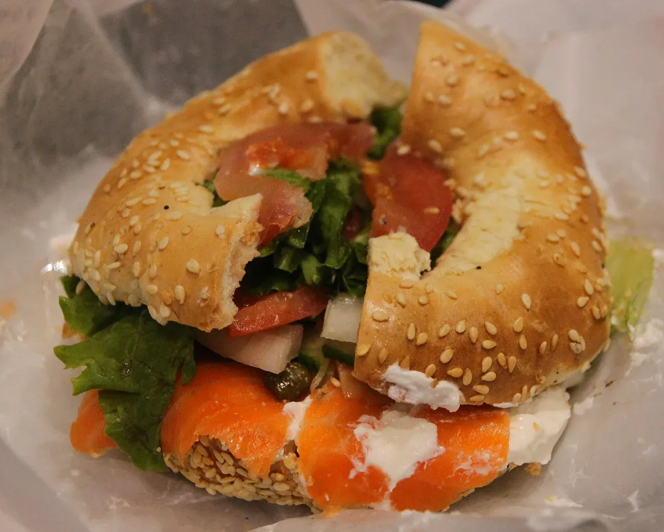 A sesame Montreal-style bagel filled with smoked salmon and cream cheese