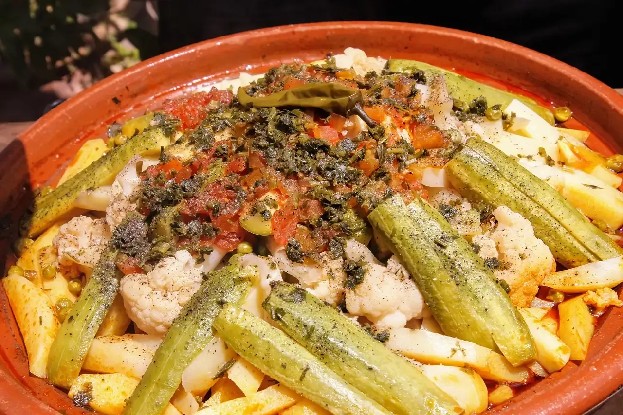 A Moroccan tagine of vegetables and olives in its clay dish