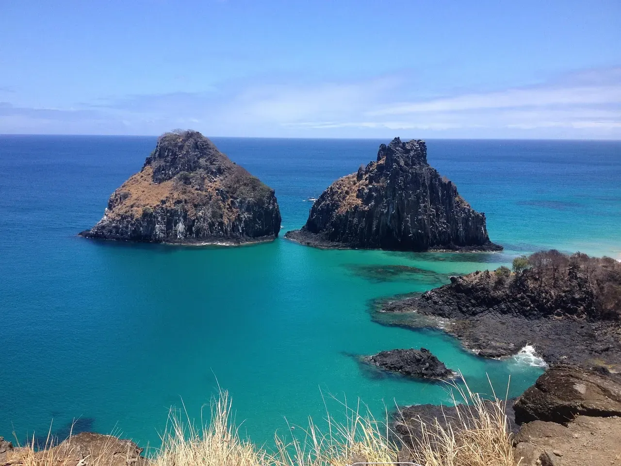 The twin rocks of Morro Dois Irmaos rising from the sea at Fernando de Noronha