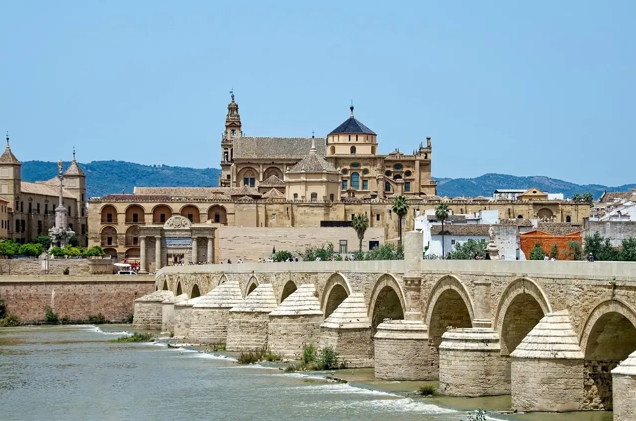 The Mosque-Cathedral of Cordoba behind the Roman bridge over the Guadalquivir