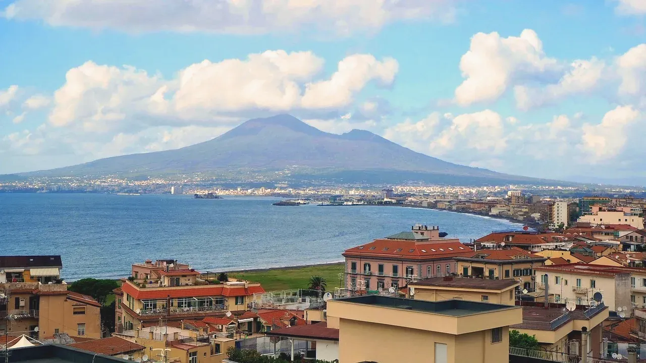 Mount Vesuvius rising above a coastal town on the Bay of Naples