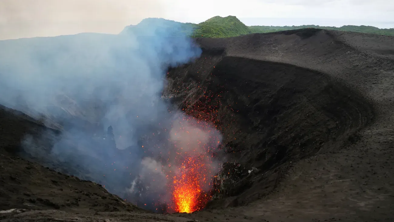 Glowing lava erupting inside the crater of Mount Yasur on Tanna, Vanuatu