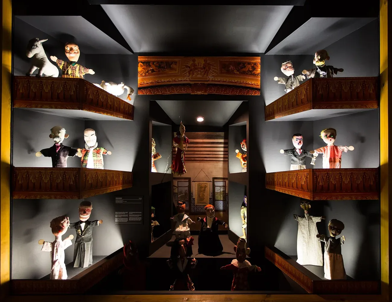 Traditional hand puppets displayed in a theatre-box arrangement at the Museu da Marioneta in Lisbon