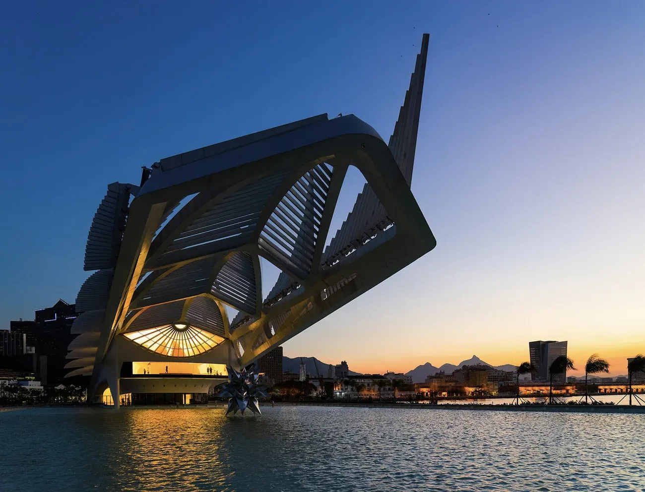 The Museum of Tomorrow lit at dusk beside the port of Rio de Janeiro