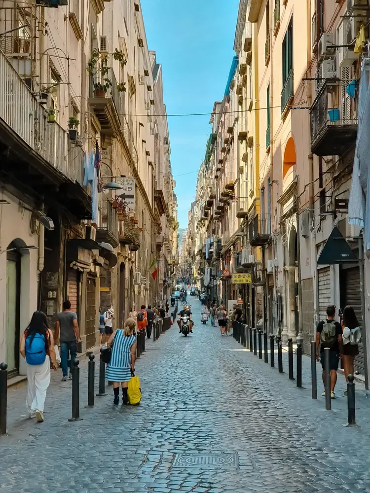 The narrow, straight Spaccanapoli street cutting through the old town of Naples