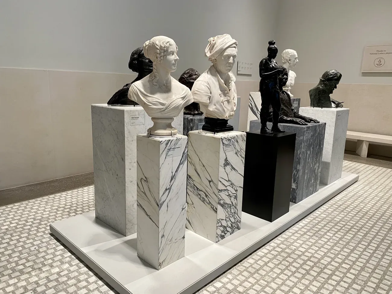 Marble portrait busts on plinths in a gallery of the National Portrait Gallery in London