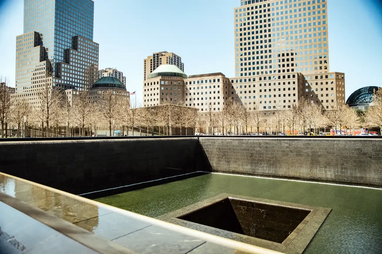Reflecting pool at the National September 11 Memorial with the Manhattan skyline behind it, New York City