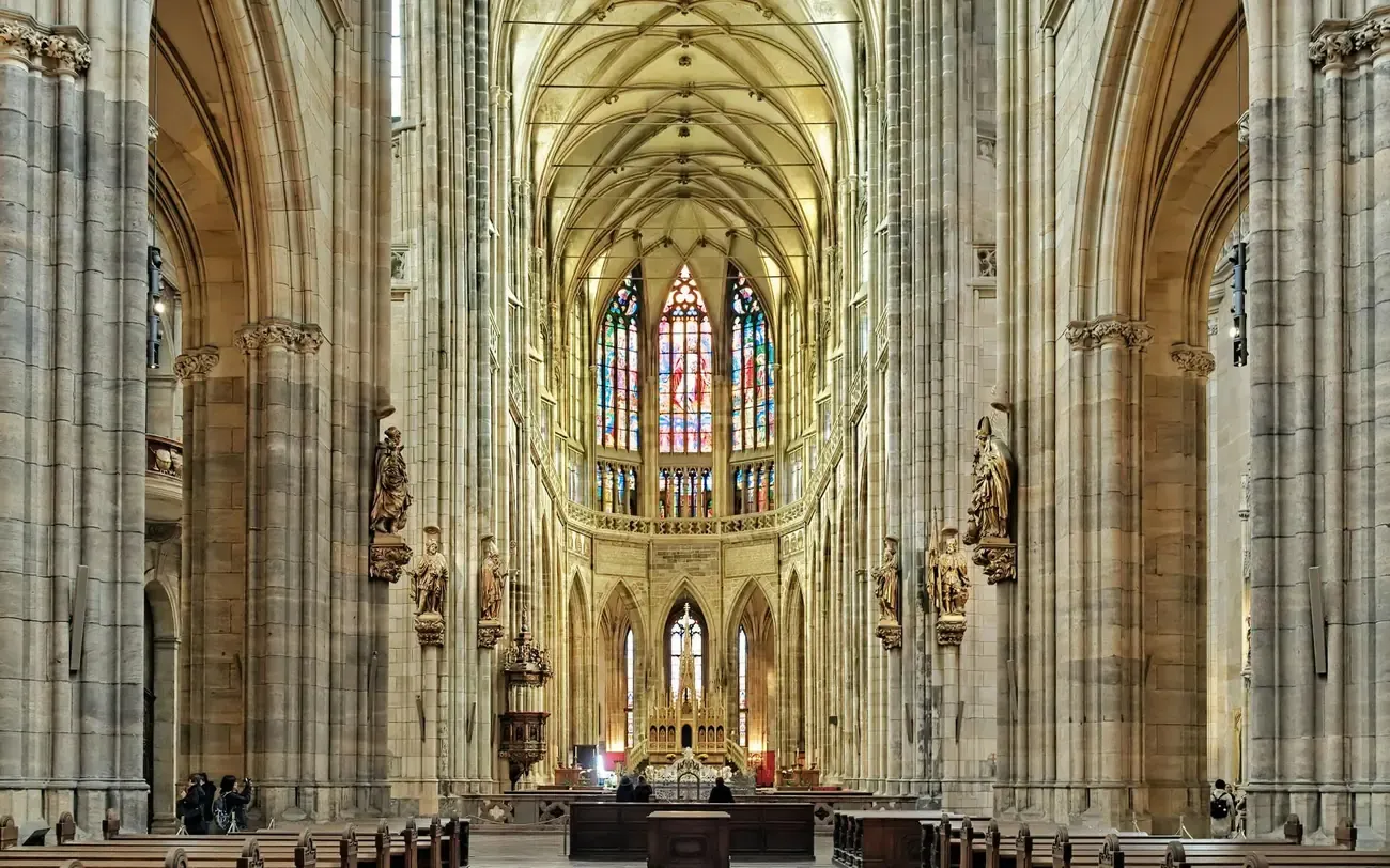 The vaulted nave and stained glass of St Vitus Cathedral in Prague