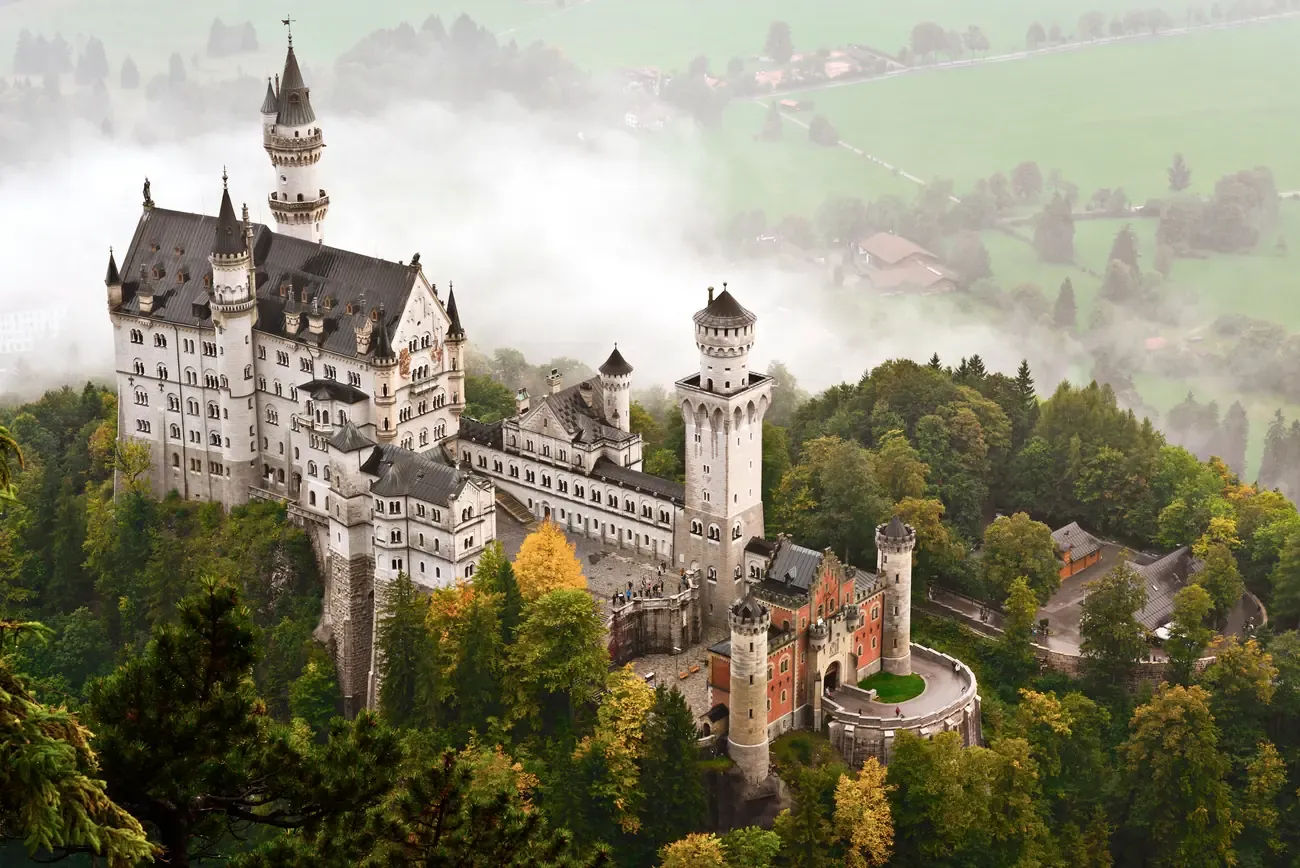 Neuschwanstein Castle rising above autumn mist near Fussen