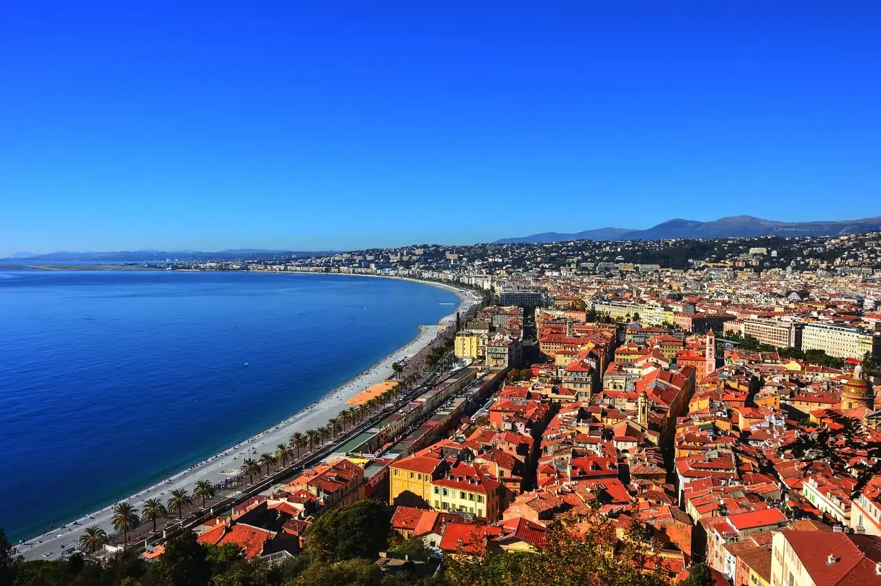 Terracotta rooftops of Nice above the Mediterranean coastline of the French Riviera