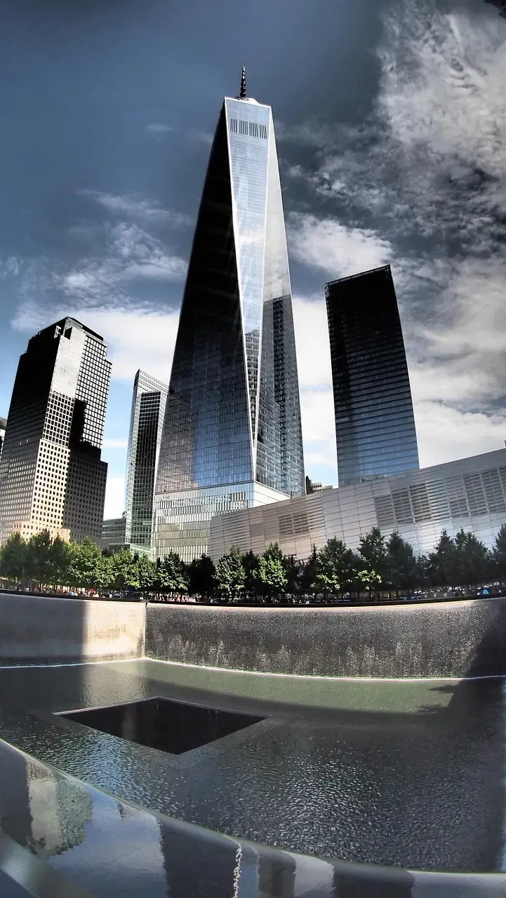 The reflecting pools of the 9/11 Memorial below the towers of the World Trade Center site in New York City