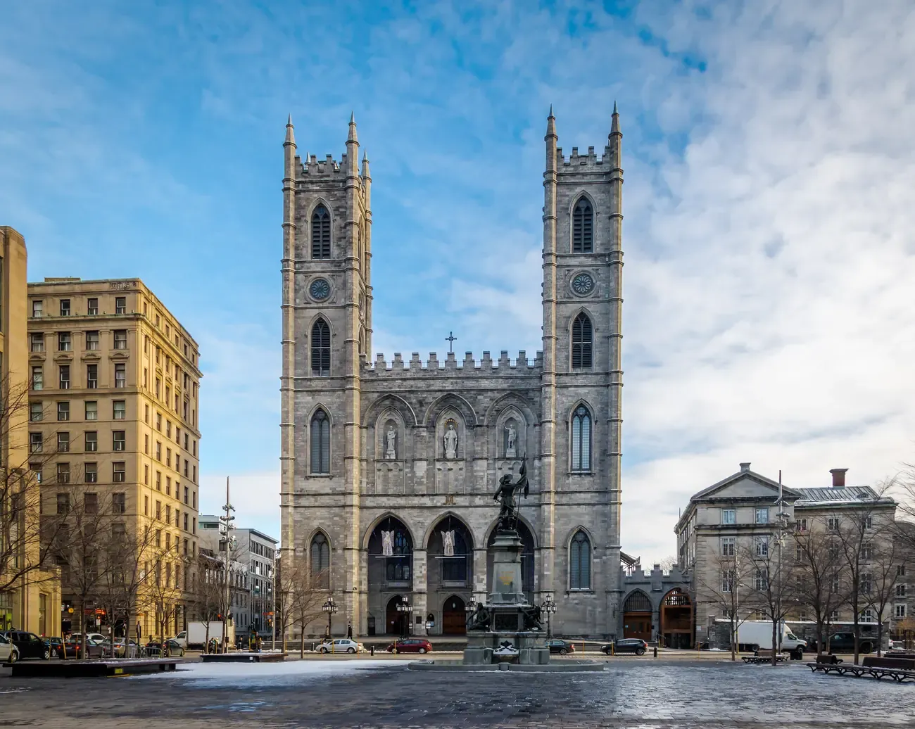 The Gothic facade of Notre-Dame Basilica at Place d'Armes in Montreal